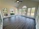 Inviting sunroom with vaulted ceiling, large windows offering peaceful backyard views at 9240 Prestwick Club Dr, Duluth, GA 30097