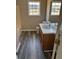 Clean bathroom with wood vanity, vinyl flooring, and bathtub at 380 River Trace Dr, Villa Rica, GA 30180