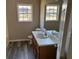 Bright bathroom featuring vinyl flooring and updated vanity at 380 River Trace Dr, Villa Rica, GA 30180