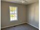 Bright bedroom featuring carpet and a large window at 380 River Trace Dr, Villa Rica, GA 30180