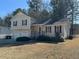 Two-story house with attached double garage and landscaped lawn at 380 River Trace Dr, Villa Rica, GA 30180