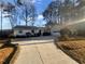 House exterior boasts a white exterior, a driveway, and mature trees at 4095 Maxanne Nw Dr, Kennesaw, GA 30144