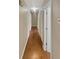 Long hallway with wood flooring and access to multiple rooms at 4095 Maxanne Nw Dr, Kennesaw, GA 30144