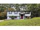 Two-story house with gray siding, red door, and stone accents at 1906 Young Rd, Lithonia, GA 30058