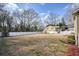 Large backyard with a white fence, with a deck and shed in background at 4293 Marietta St, Powder Springs, GA 30127