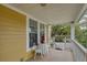 Cozy covered porch with table and chairs, inviting outdoor space, and natural light at 4293 Marietta St, Powder Springs, GA 30127