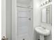 Bathroom with a shower stall, a pedestal sink, and a mirrored vanity with overhead lighting at 5200 Peachtree Rd # 3221, Chamblee, GA 30341