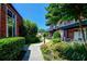 Exterior view of building with patios, lush landscaping, and a stone walkway at 5200 Peachtree Rd # 3221, Chamblee, GA 30341