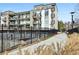 Exterior view of apartment complex featuring stylish balconies and a well-kept walkway and grassy area at 5200 Peachtree Rd # 3221, Chamblee, GA 30341