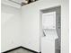 Laundry area featuring a stacked washer and dryer unit, and clean, white walls at 5200 Peachtree Rd # 3221, Chamblee, GA 30341