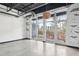 Open living area with concrete floors and large windows with a view at 5200 Peachtree Rd # 3221, Chamblee, GA 30341