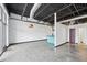 Open-concept living space with high ceilings, concrete floors, and a modern kitchen in the background at 5200 Peachtree Rd # 3221, Chamblee, GA 30341