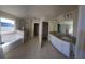 Large bathroom with double vanity, tile floor, and a garden tub at 2308 Hanover Woods Rd, Lithonia, GA 30058