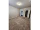 Simple carpeted bedroom with neutral walls and two closets at 2308 Hanover Woods Rd, Lithonia, GA 30058