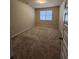 Spacious carpeted bedroom with neutral walls and large window at 2308 Hanover Woods Rd, Lithonia, GA 30058