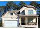 Two-story house with beige siding, white garage door, and a front porch at 2308 Hanover Woods Rd, Lithonia, GA 30058