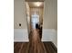 Hallway with hardwood floors leading to the kitchen at 2308 Hanover Woods Rd, Lithonia, GA 30058