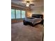 Main bedroom with large windows, carpet, and a king-size bed at 2308 Hanover Woods Rd, Lithonia, GA 30058