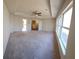 Main bedroom with tray ceiling, carpet, and large windows at 2308 Hanover Woods Rd, Lithonia, GA 30058