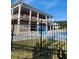 Community pool with a black metal fence and large home in background at 2308 Hanover Woods Rd, Lithonia, GA 30058