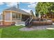 Inviting backyard deck with an umbrella-shaded table, accessed by stairs from a stone patio and lush lawn at 100 Pine Sandy Bank Dr, Canton, GA 30114