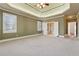 Large bedroom featuring tray ceiling, neutral walls, and carpet floors at 100 Pine Sandy Bank Dr, Canton, GA 30114