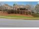 Charming two-story home featuring stone accents, lush landscaping, and a well-maintained yard at 100 Pine Sandy Bank Dr, Canton, GA 30114