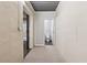 Hallway with neutral carpet, leading to a full bathroom with white fixtures at 100 Pine Sandy Bank Dr, Canton, GA 30114