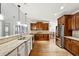 Spacious kitchen featuring dark wood cabinets, granite countertops, and stainless steel refrigerator at 100 Pine Sandy Bank Dr, Canton, GA 30114