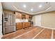 Basement kitchenette featuring wood cabinets, stainless steel appliances, and wood-look tile flooring at 100 Pine Sandy Bank Dr, Canton, GA 30114