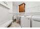 Bright laundry room with built-in sink, shelving, cabinetry, and a modern washer and dryer at 100 Pine Sandy Bank Dr, Canton, GA 30114