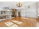Open-concept living room featuring hardwood floors and a stone fireplace at 100 Pine Sandy Bank Dr, Canton, GA 30114