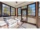 Relaxing screened-in porch with a hanging swing bed and wooded views at 100 Pine Sandy Bank Dr, Canton, GA 30114