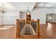 View of open staircase with hardwood floors and wrought iron railing at 100 Pine Sandy Bank Dr, Canton, GA 30114