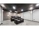 Cozy theater room in basement with projector, screen, and leather reclining chairs at 100 Pine Sandy Bank Dr, Canton, GA 30114