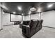Finished basement theater room with black leather seating, projector, and a big screen at 100 Pine Sandy Bank Dr, Canton, GA 30114