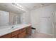 Bright bathroom with a large mirror, single vanity, tile floors, and a separate glass enclosed shower at 2657 Avanti Way, Decatur, GA 30035