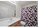 Bathroom features a single vanity and a shower with geometric patterned shower curtain at 2657 Avanti Way, Decatur, GA 30035