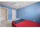Light blue bedroom with carpet, ceiling fan and bed. Features a closed white door to another room at 2657 Avanti Way, Decatur, GA 30035