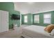 Bedroom features a white bed, green walls, carpet floor, and three windows at 2657 Avanti Way, Decatur, GA 30035