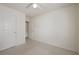 Bedroom with neutral carpet, white walls and ceiling fan. Doorway visible to another room at 2657 Avanti Way, Decatur, GA 30035