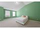 Bedroom features a white bed, carpet floor, and two windows at 2657 Avanti Way, Decatur, GA 30035