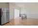 Open dining area with stainless steel refrigerator, wood floor, and chandelier at 2657 Avanti Way, Decatur, GA 30035