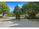 Gated community entrance with mature trees and manicured landscaping at 2657 Avanti Way, Decatur, GA 30035
