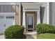 Close-up of the front door, showing the address, well-kept bushes, and partial garage door at 2657 Avanti Way, Decatur, GA 30035