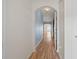 Hallway with wood floors, an archway leading to more rooms, and soft blue accent wall at 2657 Avanti Way, Decatur, GA 30035
