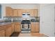 Kitchen with wood cabinets, stainless steel oven and microwave, and decorative backsplash at 2657 Avanti Way, Decatur, GA 30035
