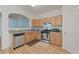 A well-lit kitchen with stainless steel appliances, wood cabinetry, and an open view at 2657 Avanti Way, Decatur, GA 30035