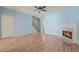 Spacious living room with wood floors, a decorative fireplace, and soft blue accent wall at 2657 Avanti Way, Decatur, GA 30035