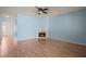 Large living room featuring wood floors, a fireplace, blue wall, and an open floor plan at 2657 Avanti Way, Decatur, GA 30035